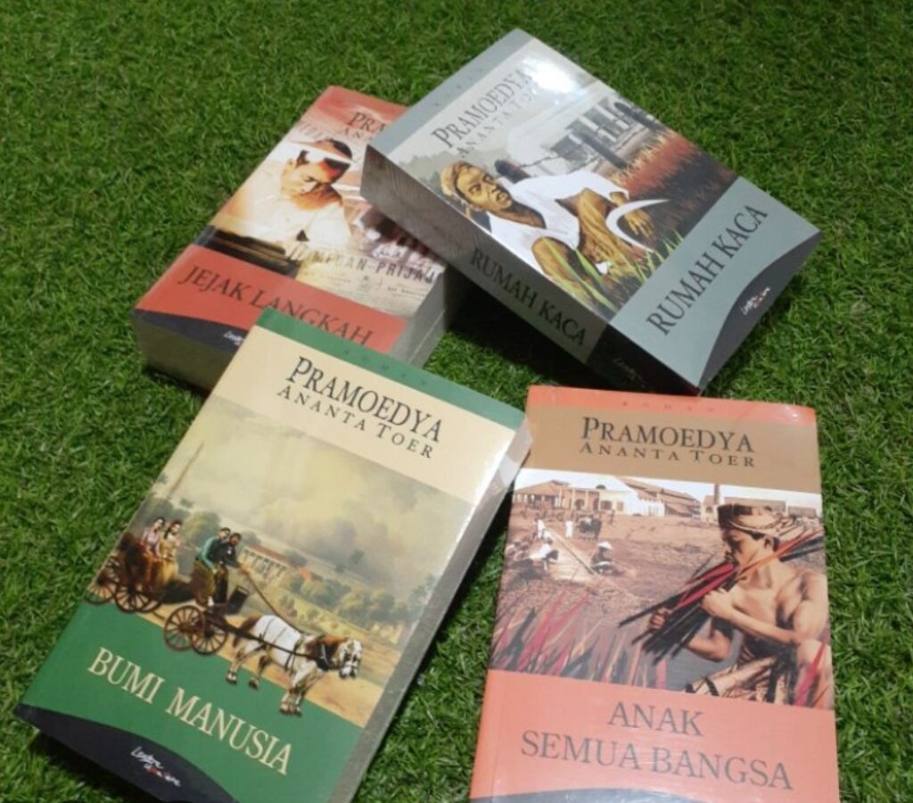Several pramoedya ananta toer novels laid on green grass including bumi manusia and anak semua bangsa